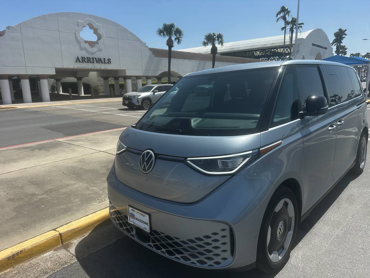 VW ID Buzz front angle at airport arrivals - electric shuttle service